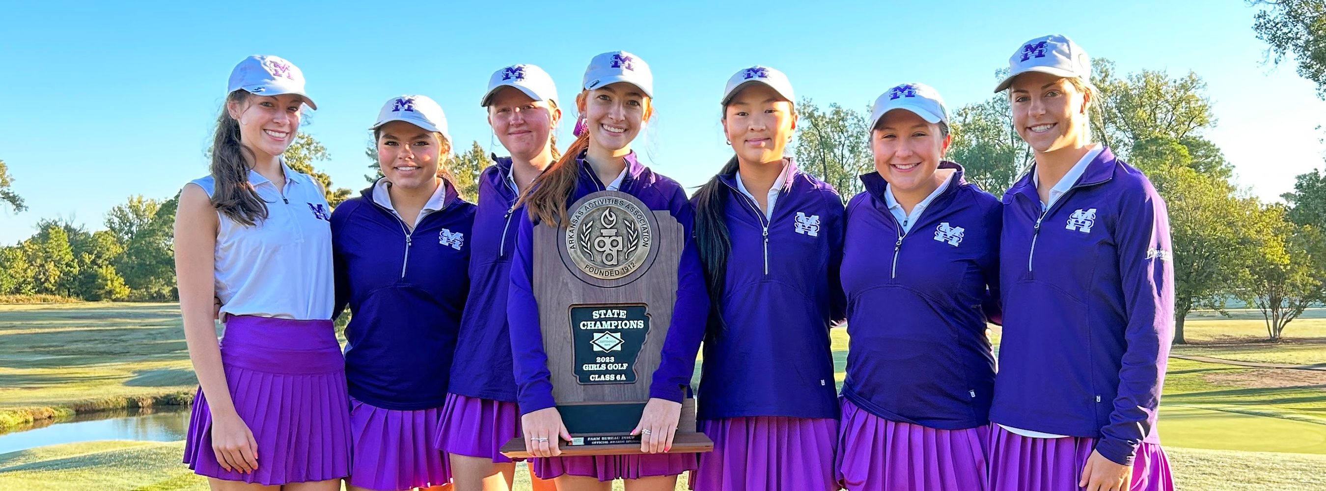 members of the Golf Belles standing with their State Championship trophy