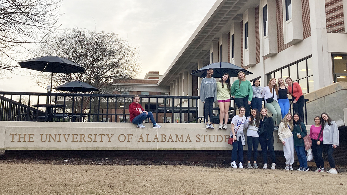 students standing in front of University of Alabama sign during college tour