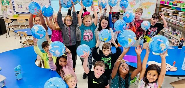 Elementary Students with globes