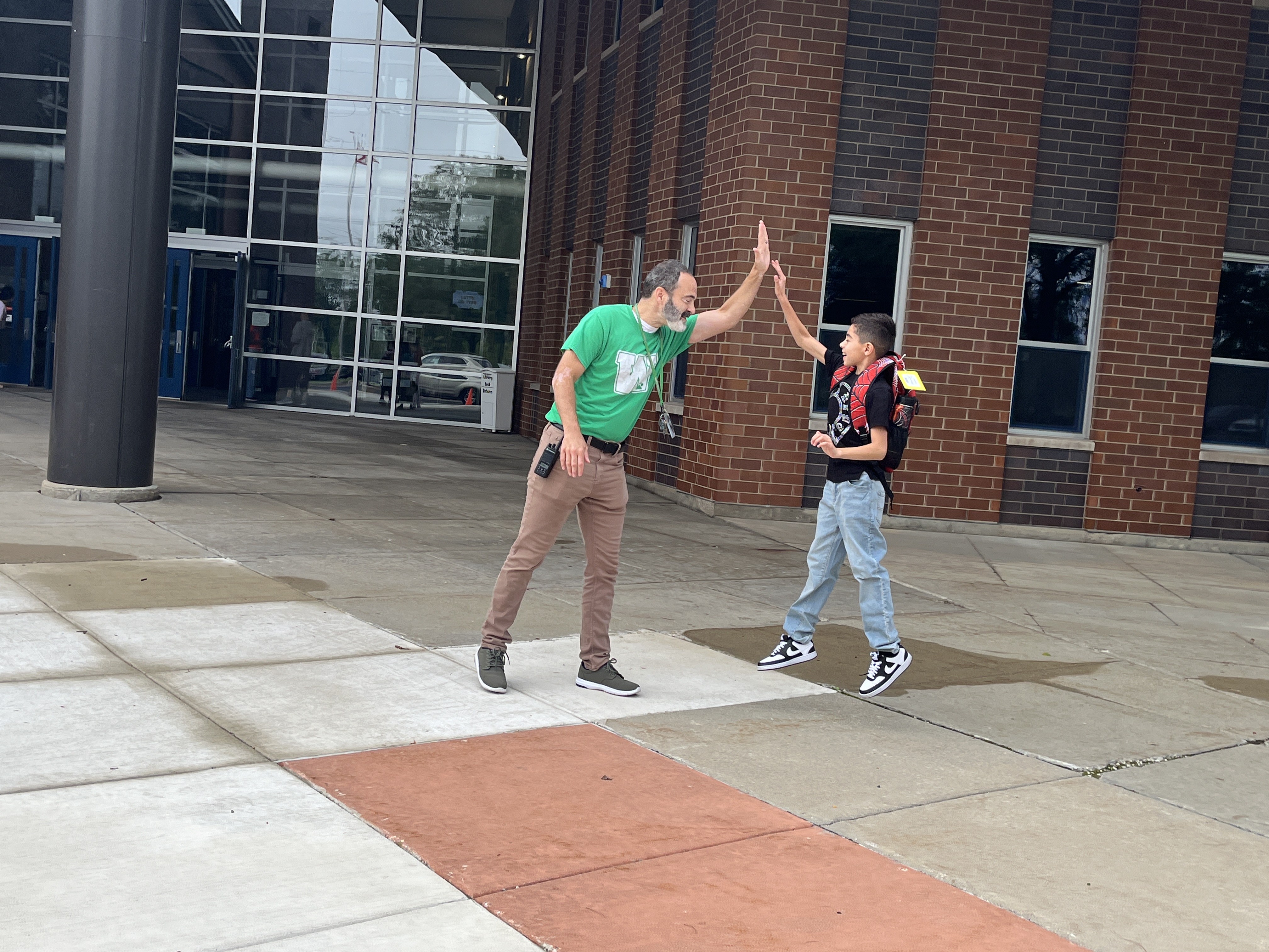 principal high-fiving a student 