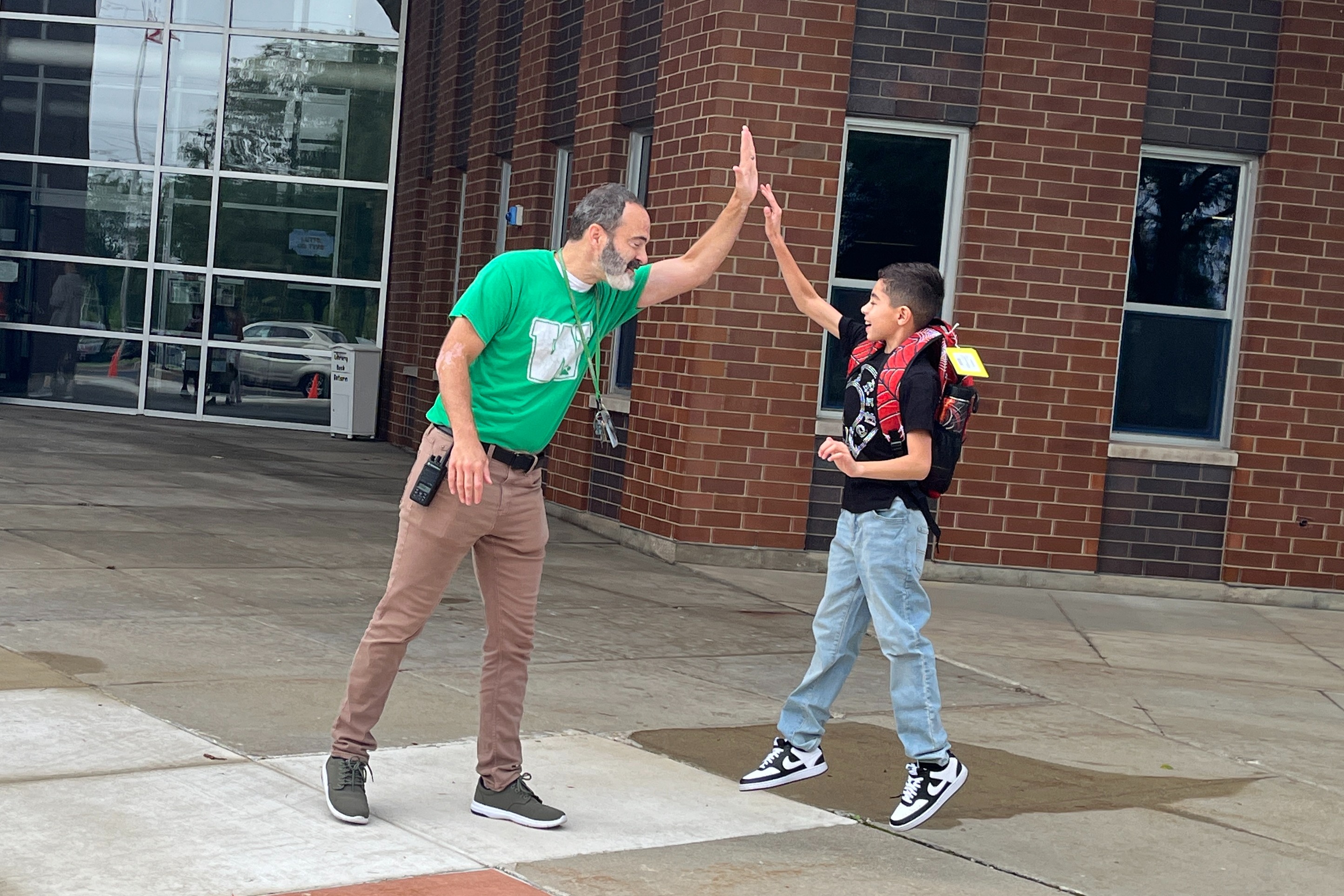 Mr. Sheldon high-fiving a student 
