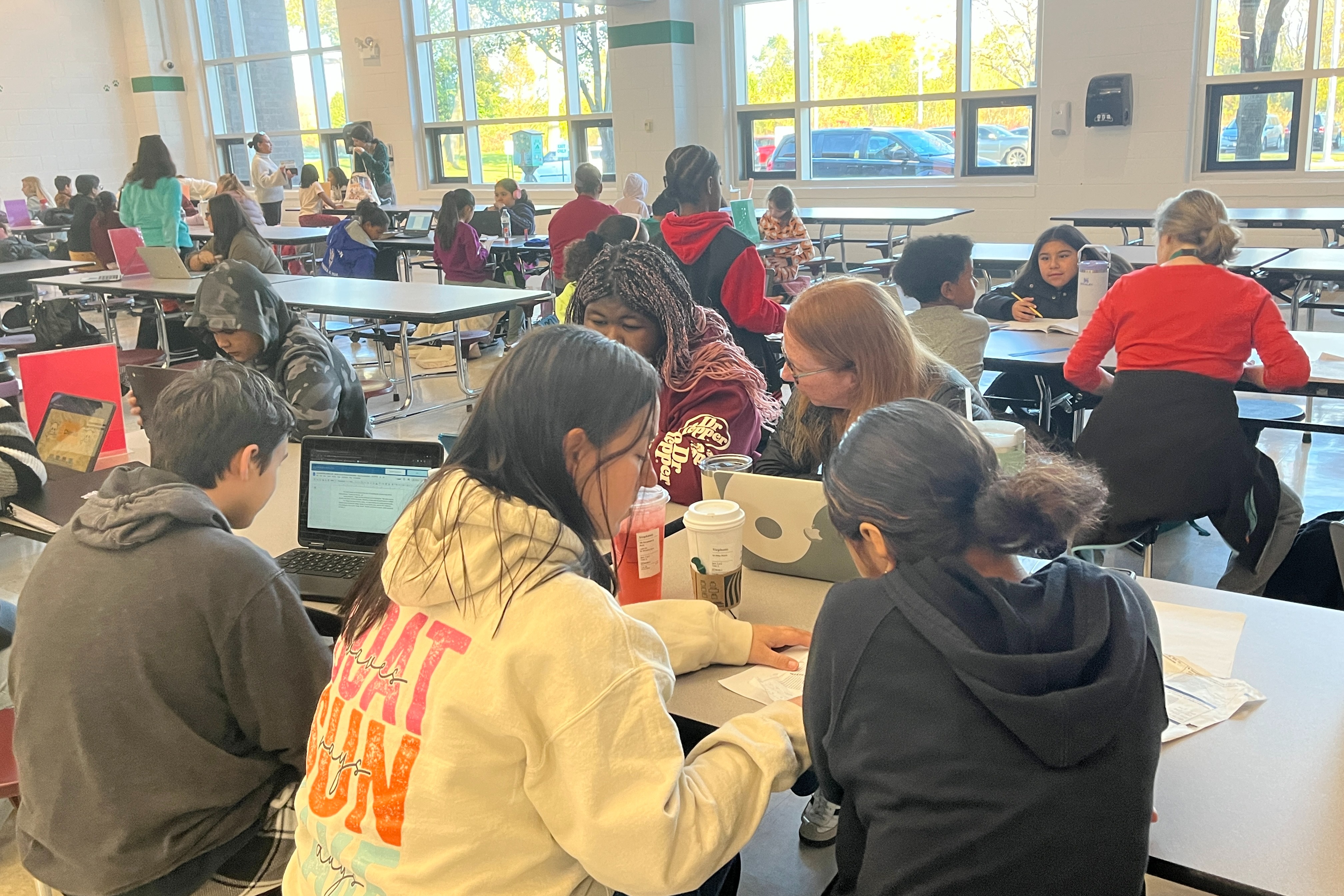 Middle School Students working with teacher in small groups