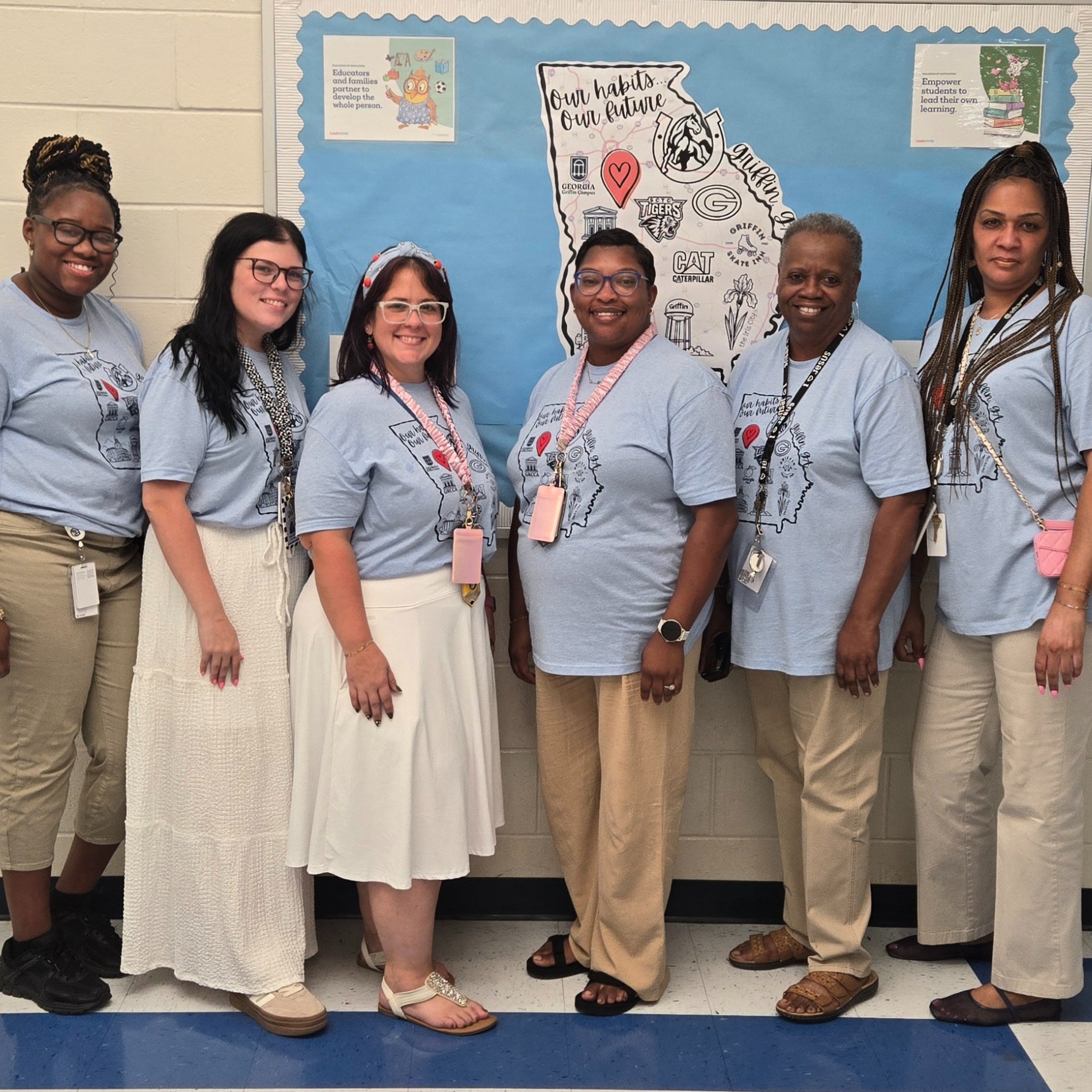 teachers in blue "Cowan Colts" tops