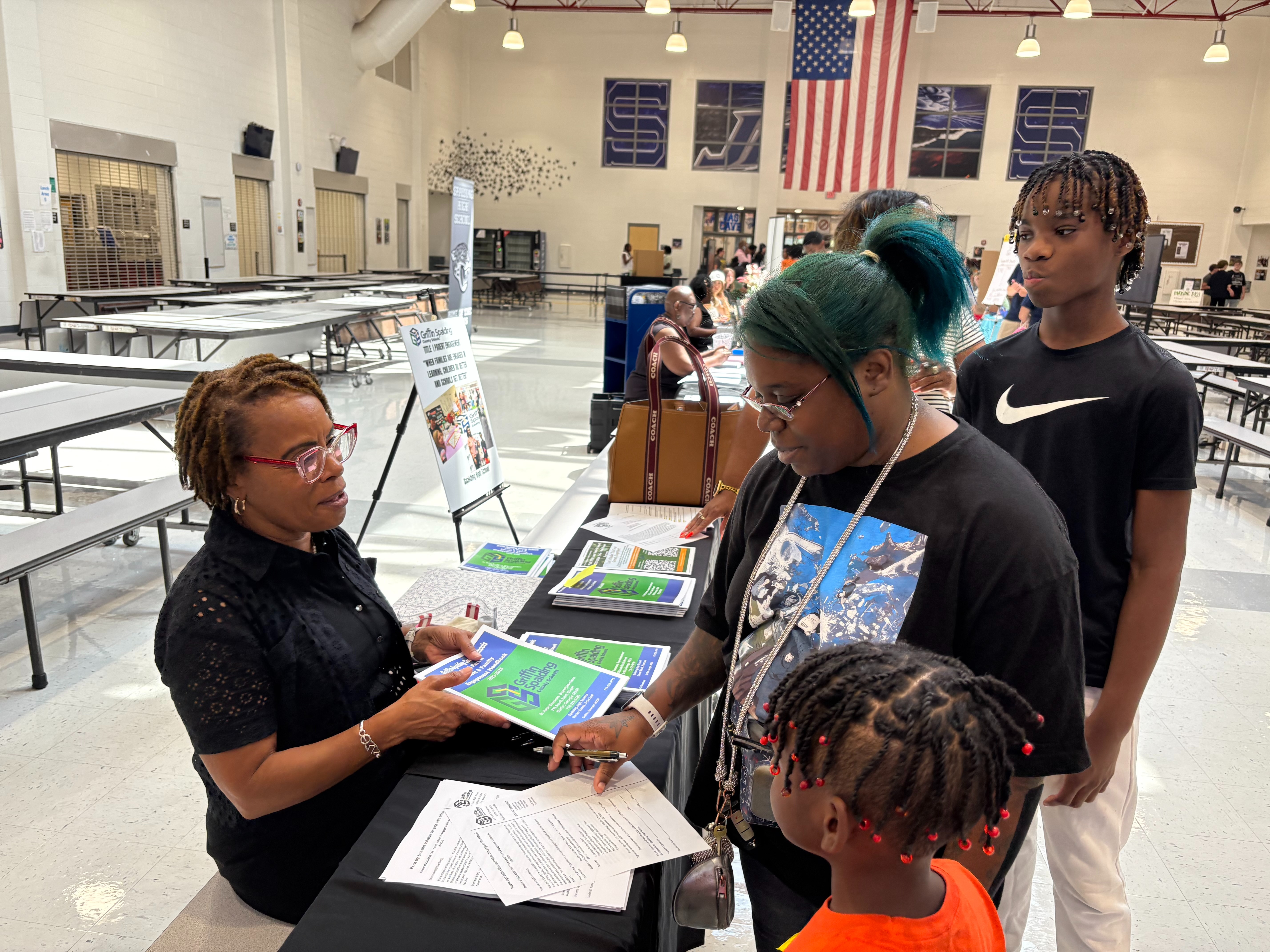 Parents discussing Title I documents at the Annual Title I Meeting