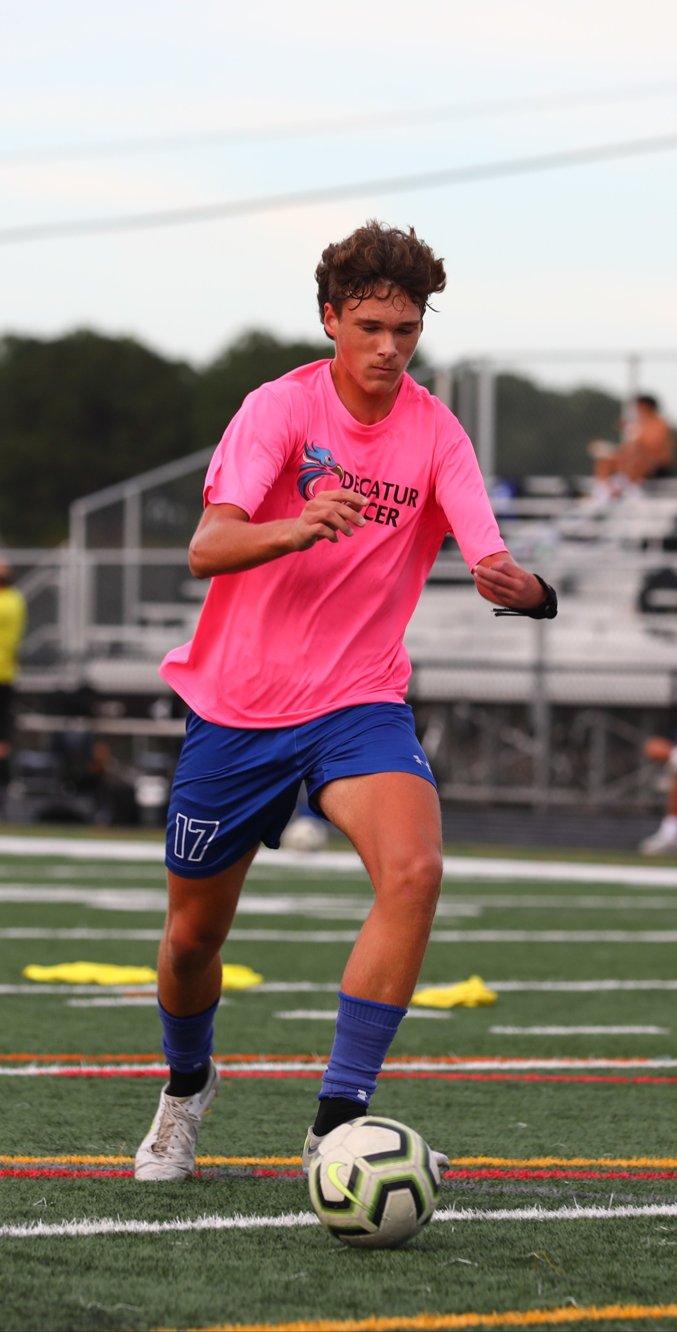 Varsity boy running up field