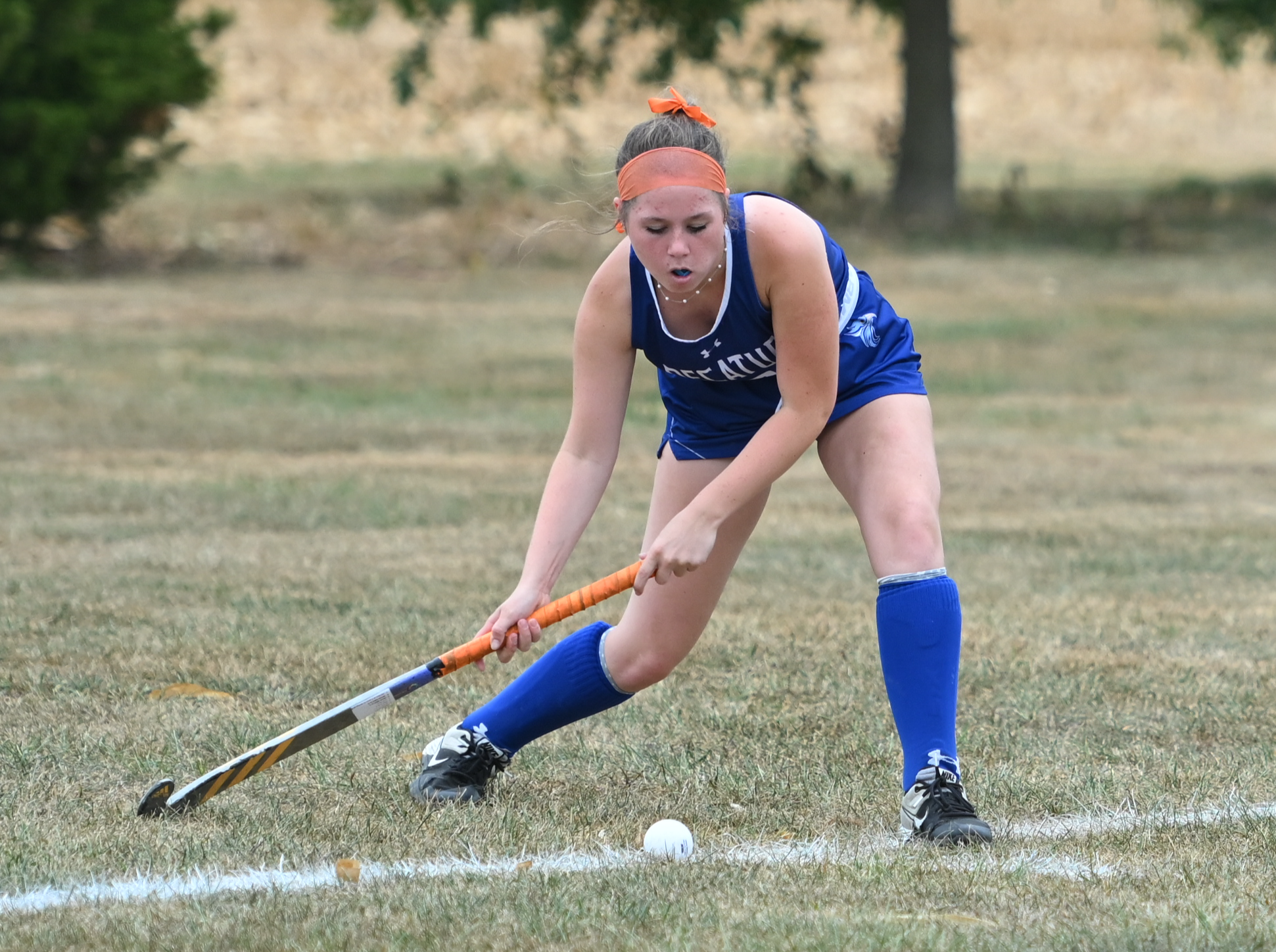 Varsity girl hitting ball