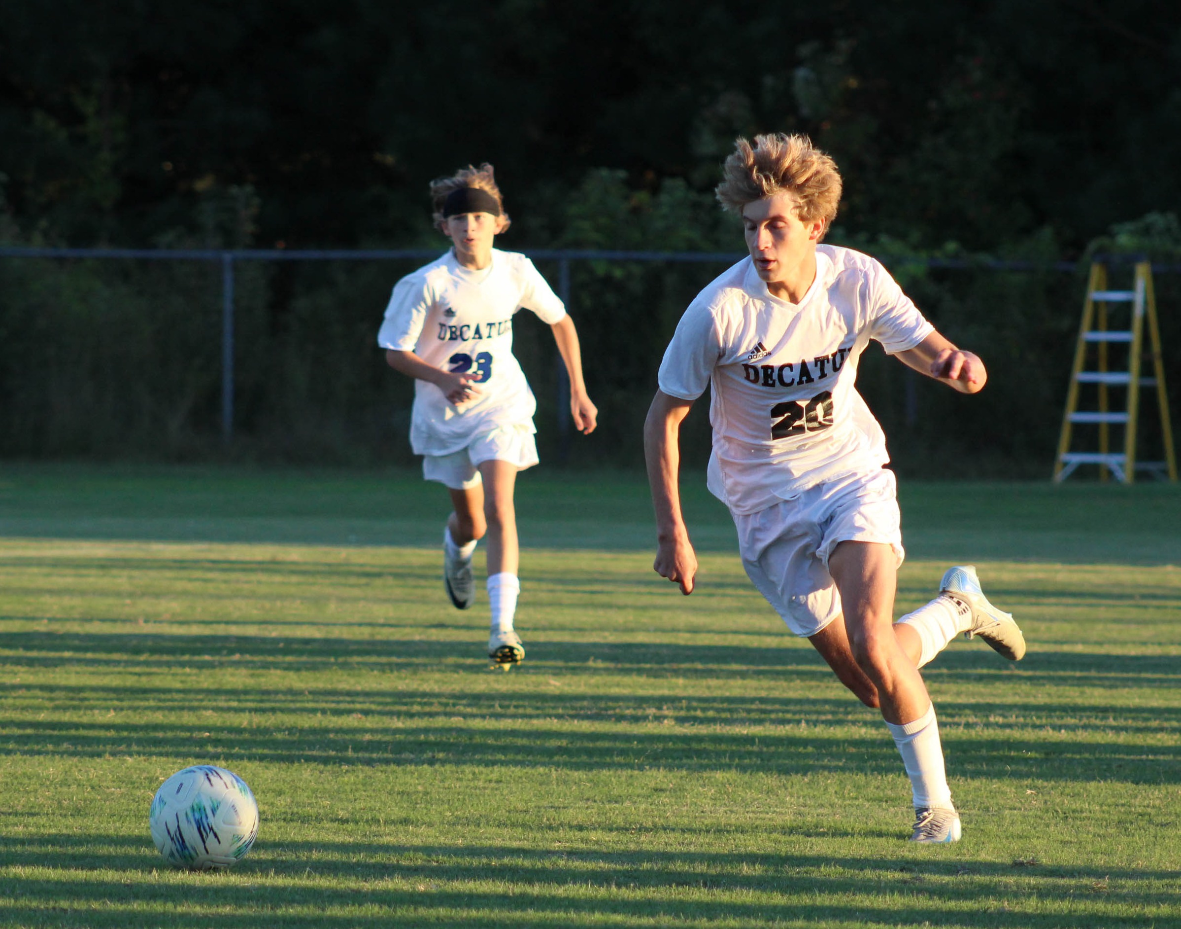 JV soccer player running on field