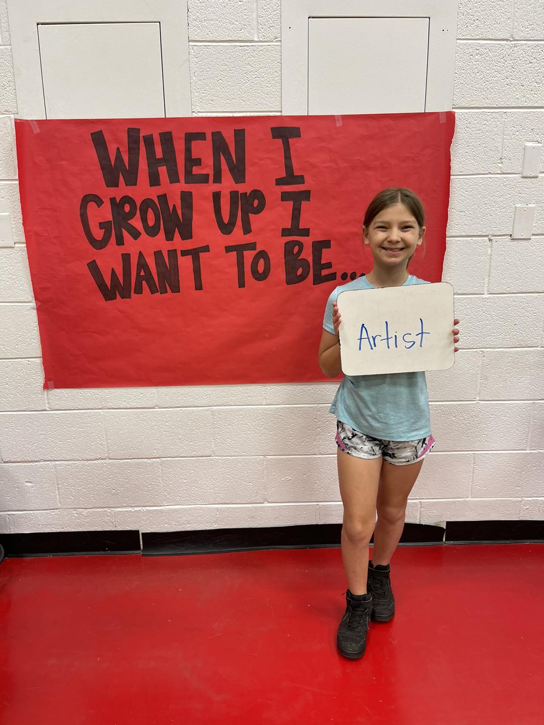 student in front of career day poster