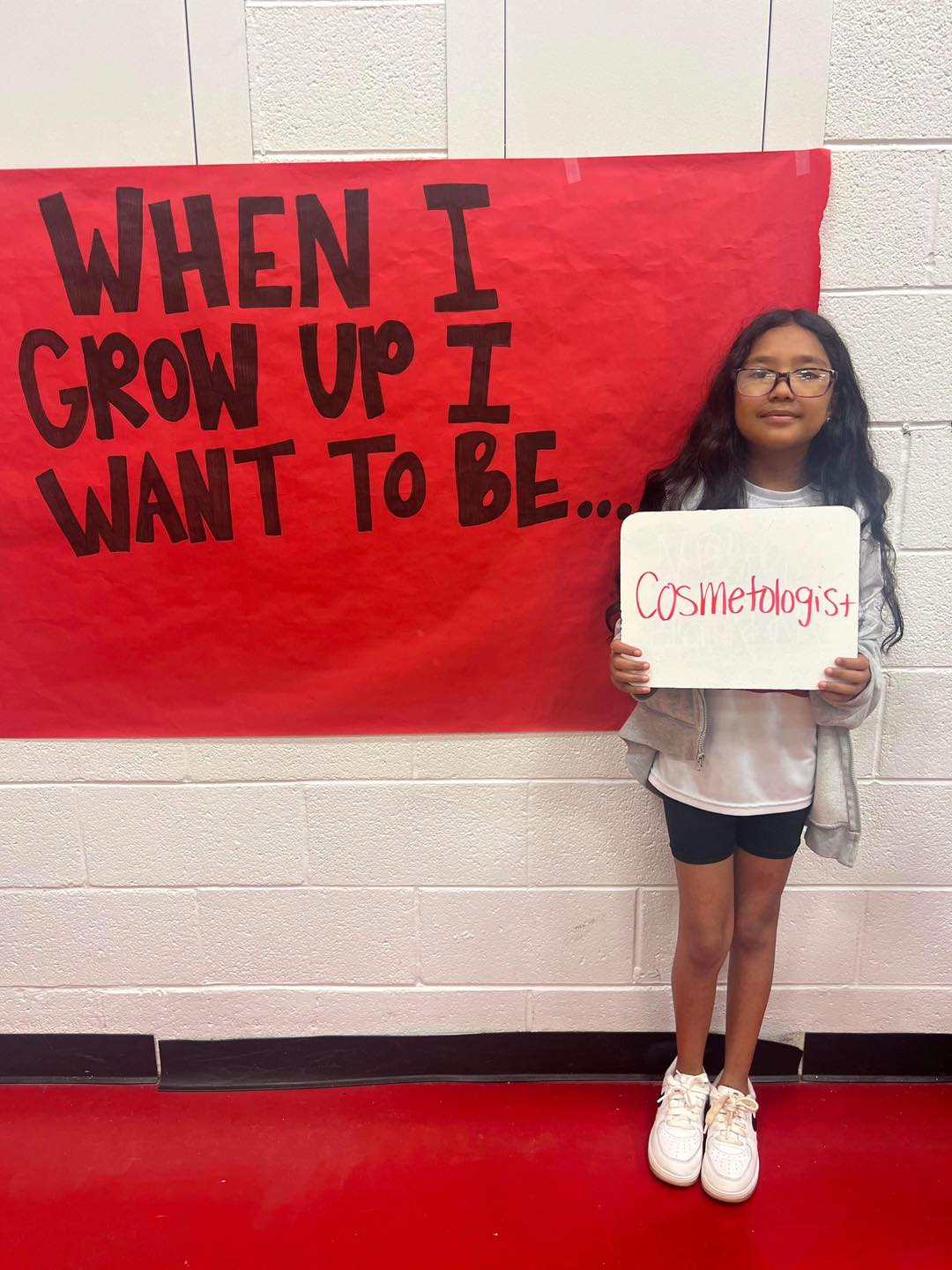 student in front of career day sign