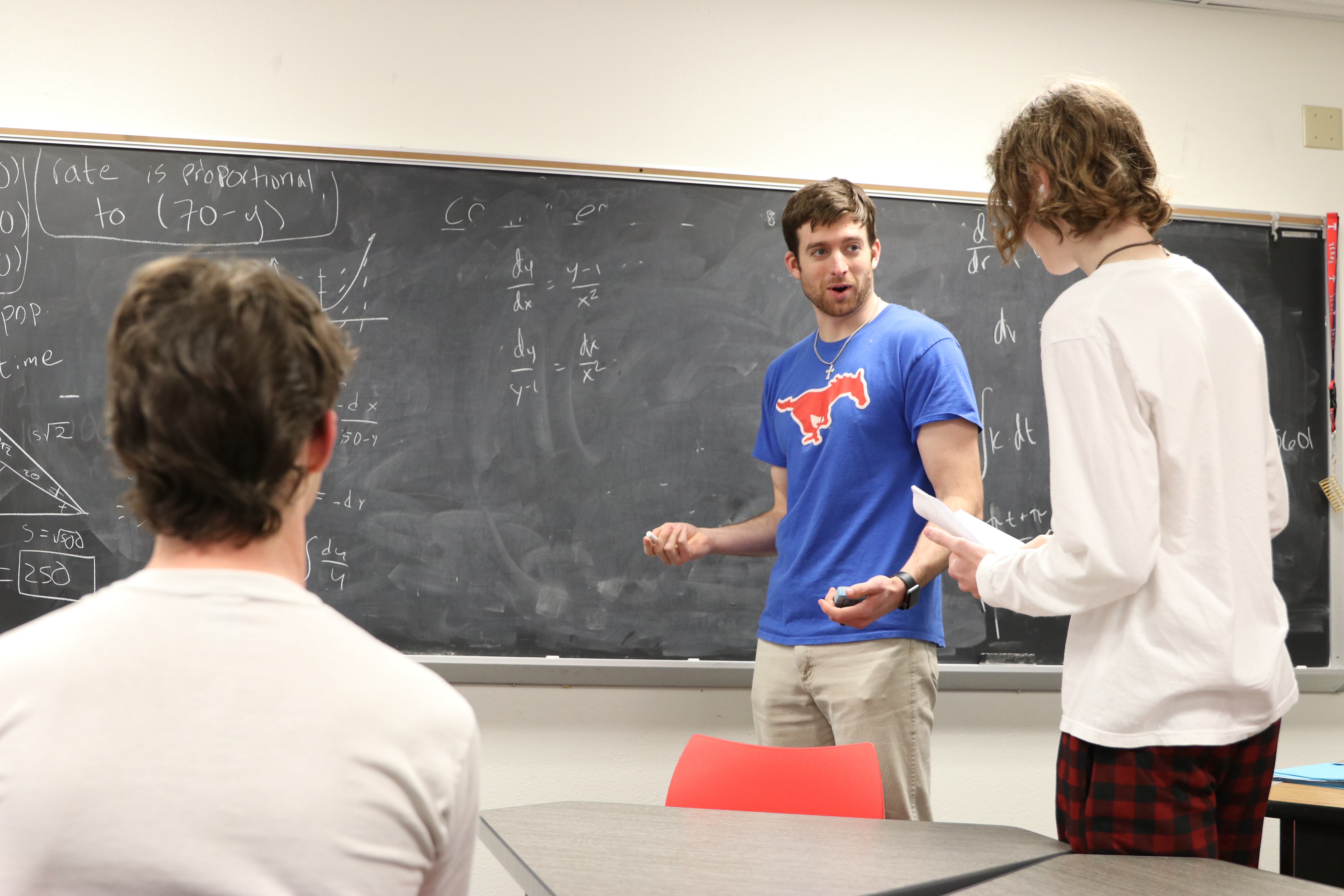 Teacher working with students on math