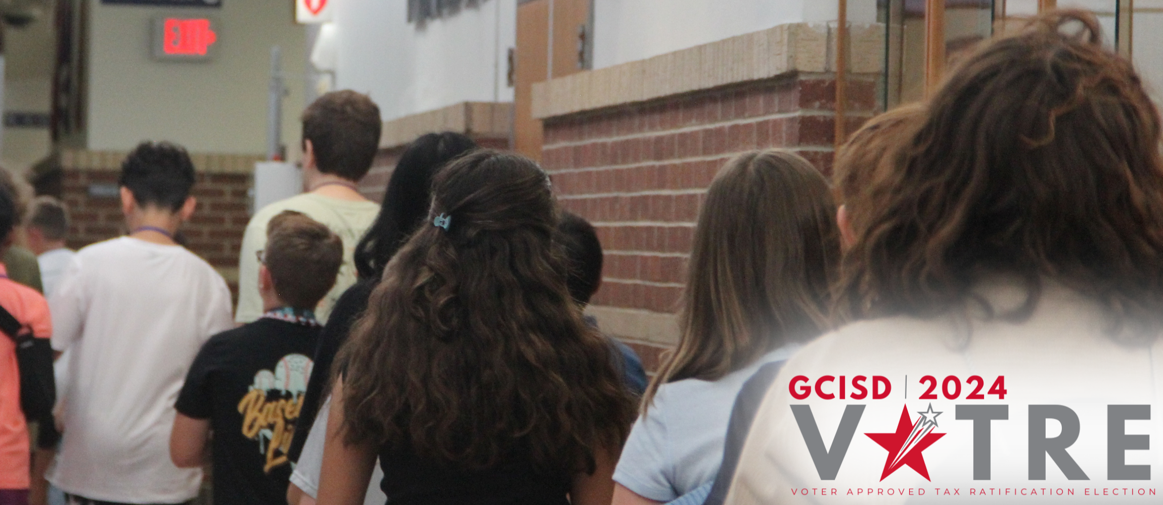 VATRE Logo over a picture of students walking to class