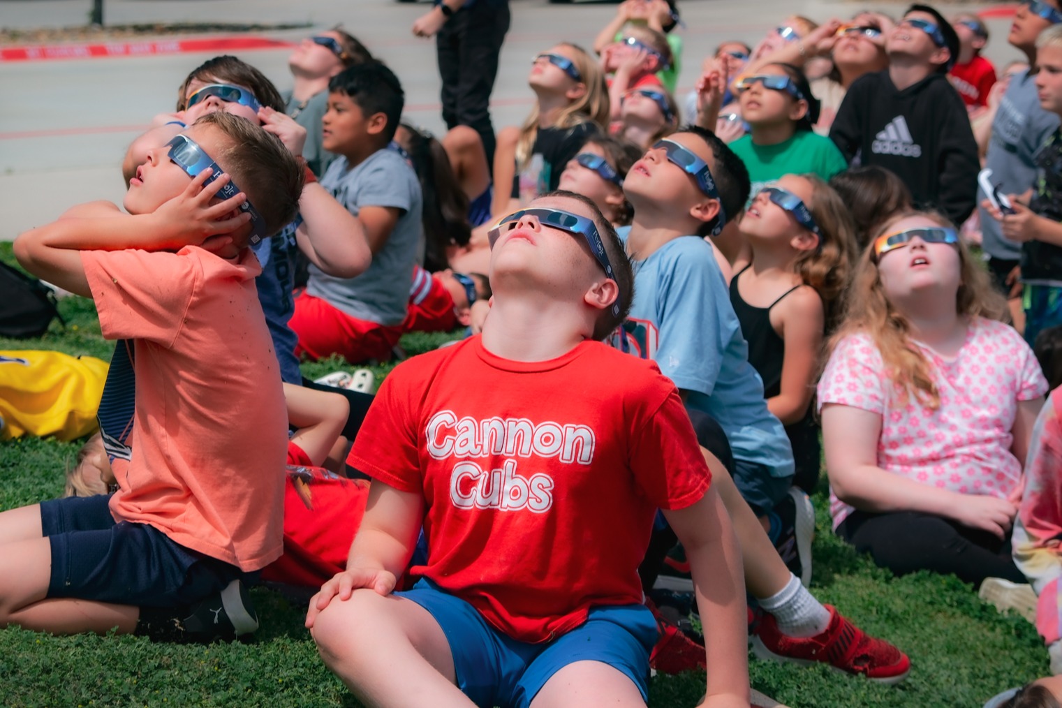 Students viewing eclipse with safety glasses