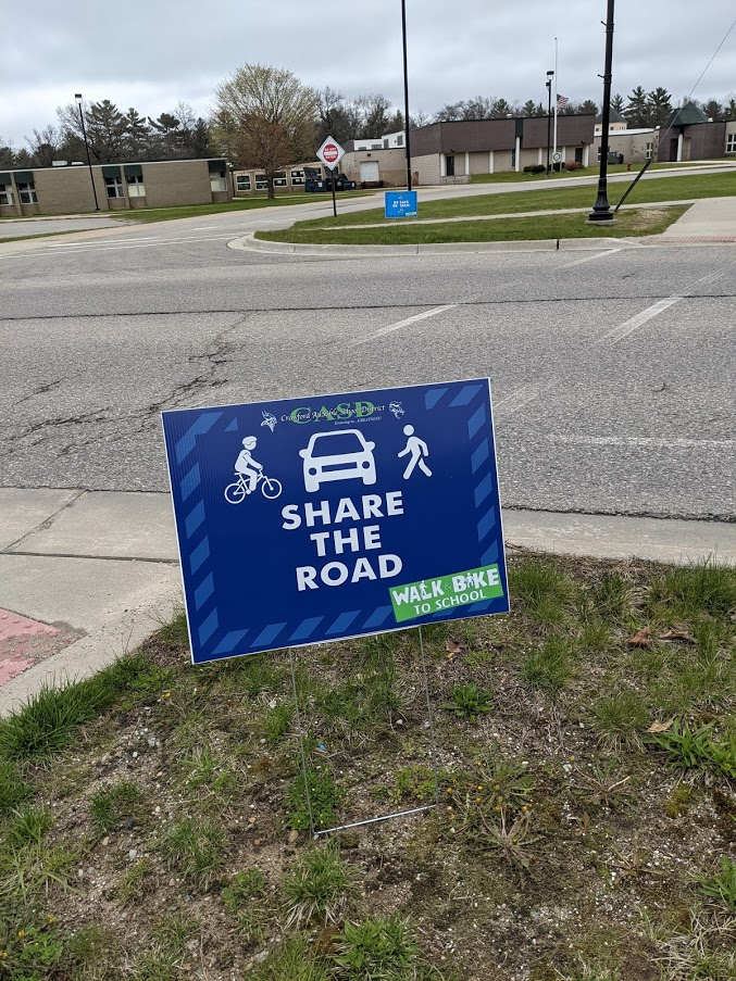 A Share the Road sign for Walk & Bike to School Day - Spring 2021