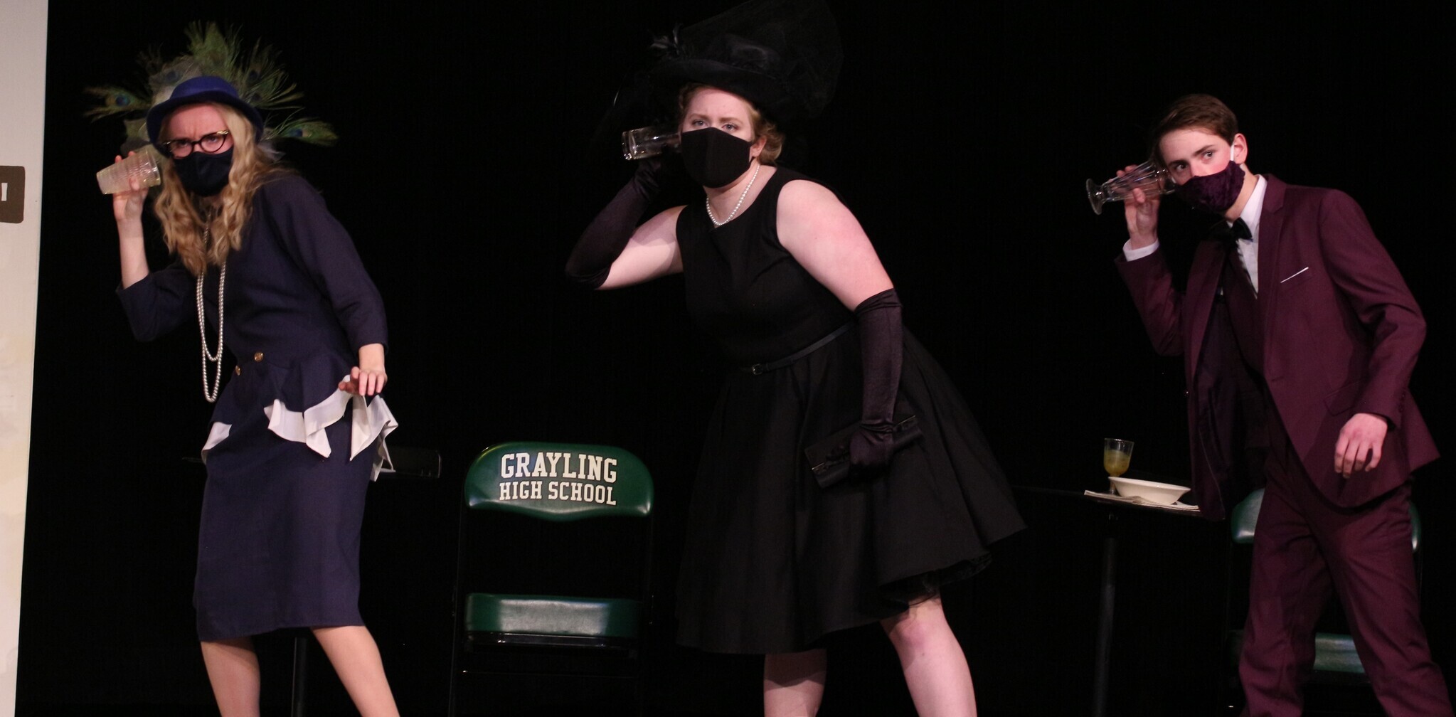 3 students as "clue" characters on stage