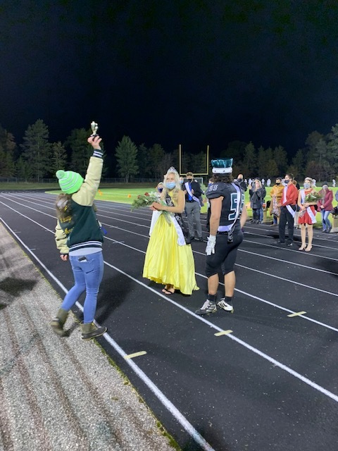 students at homecoming on football field
