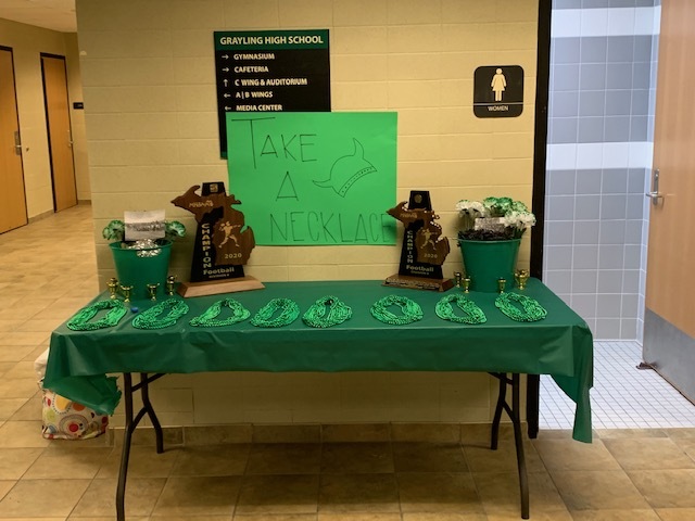 table of green items in school hallway