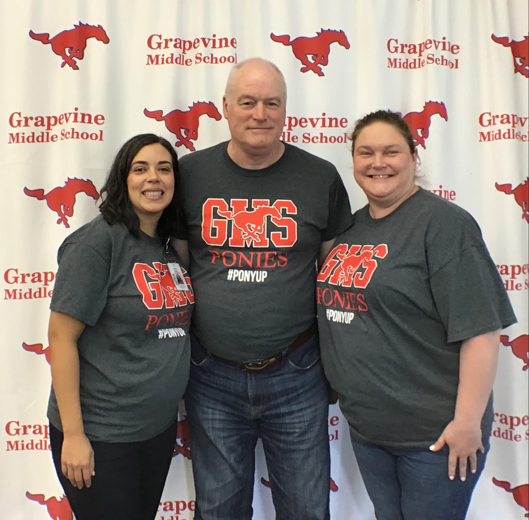 Picture of counselors and the student advocate in front of a Grapevine Middle School back drop.