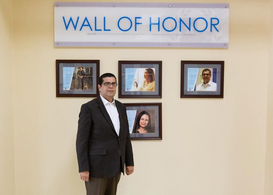Mike in front of the Wall of Honor