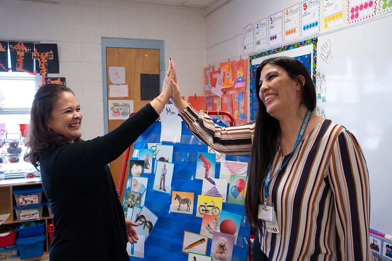 staff high-fiving in a classroom