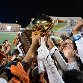 football team holding up a trophy