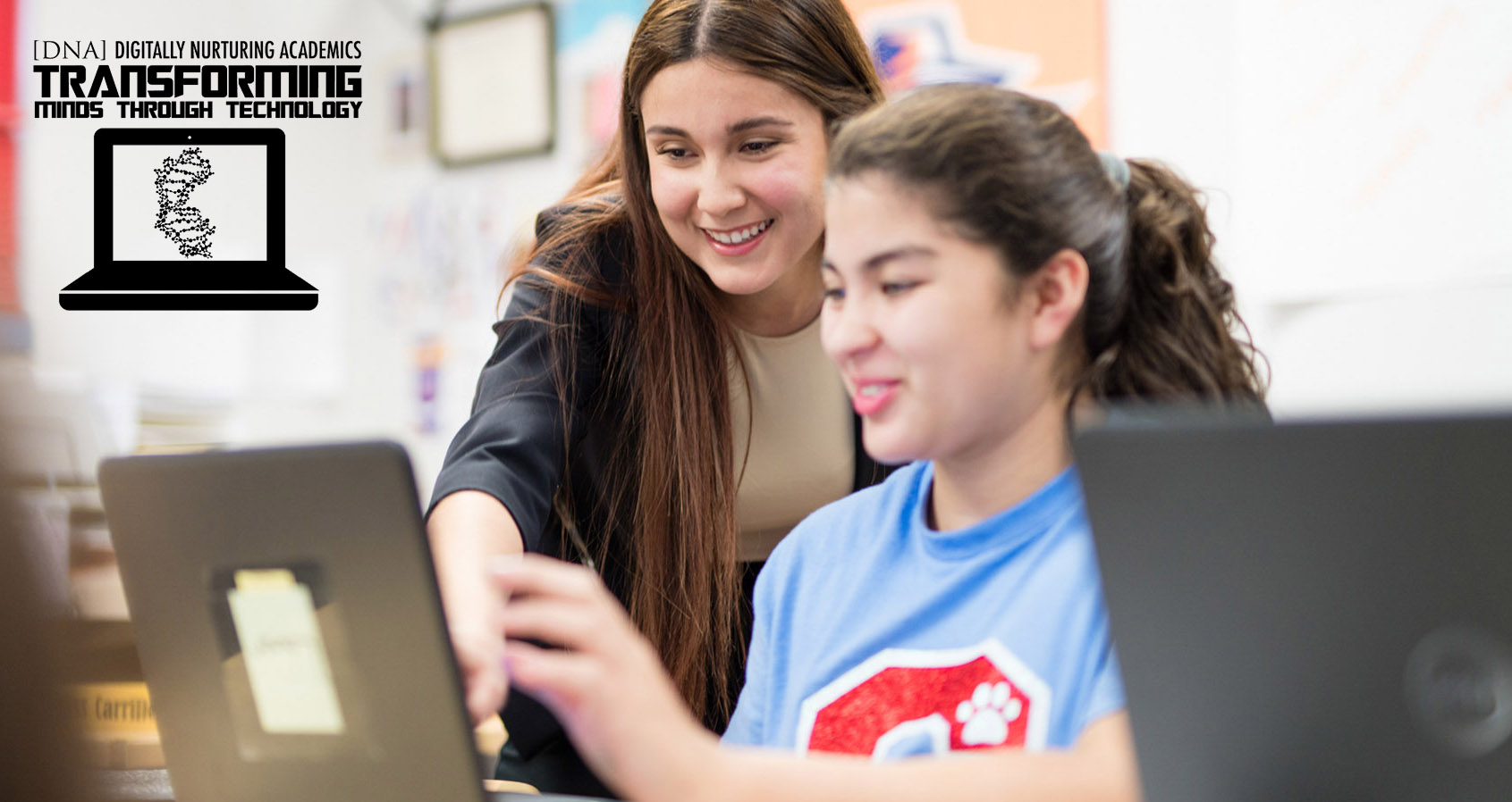 Teacher helping student with an assignment on the student's DNA issued laptop