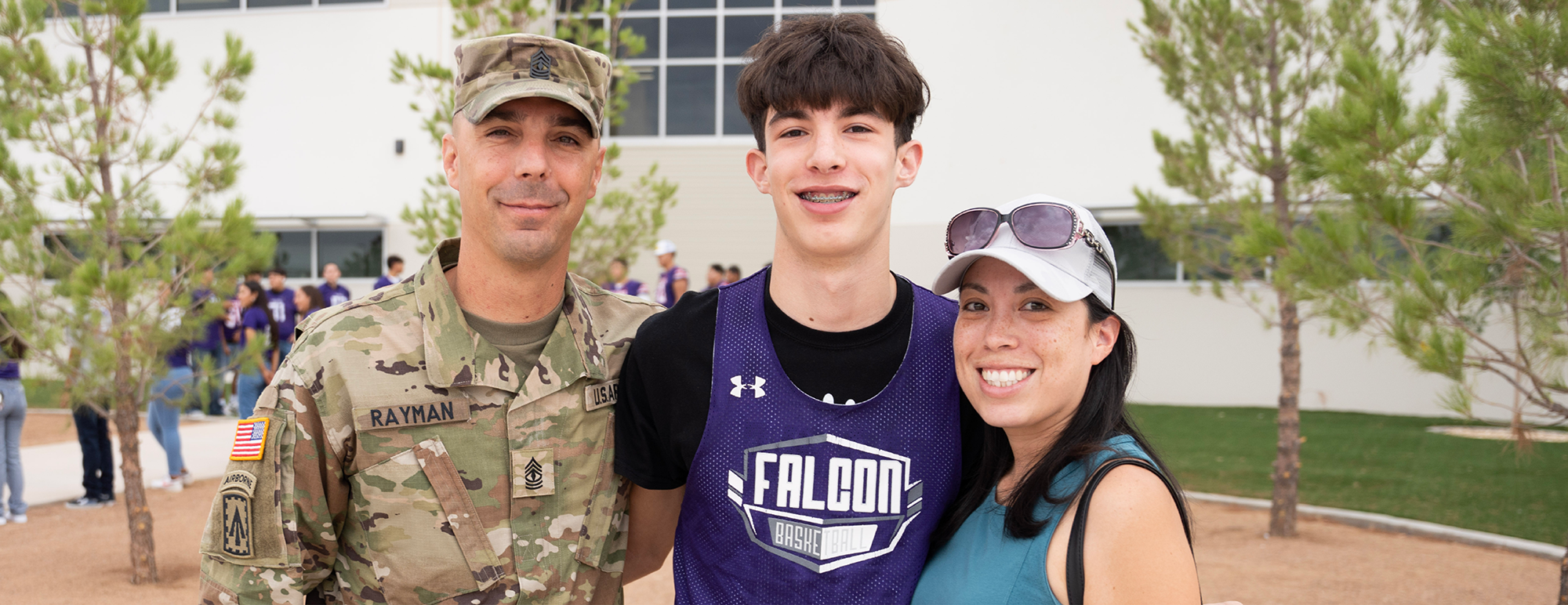 A military family with their high school student smiling