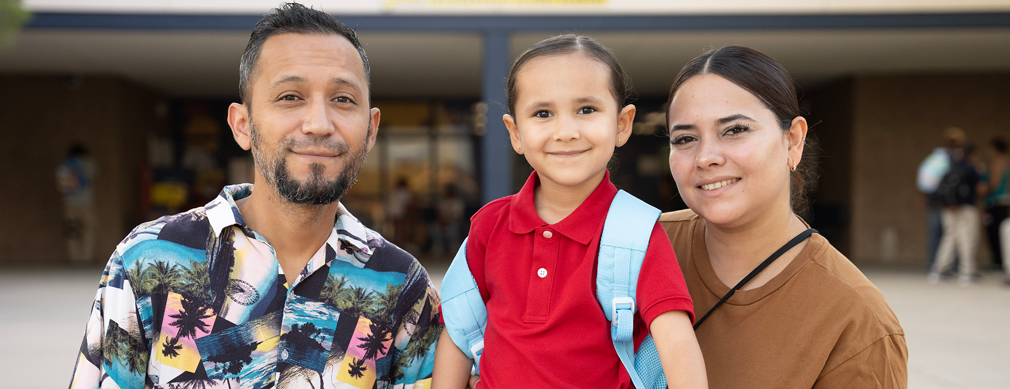 Elementary student with her family smiling