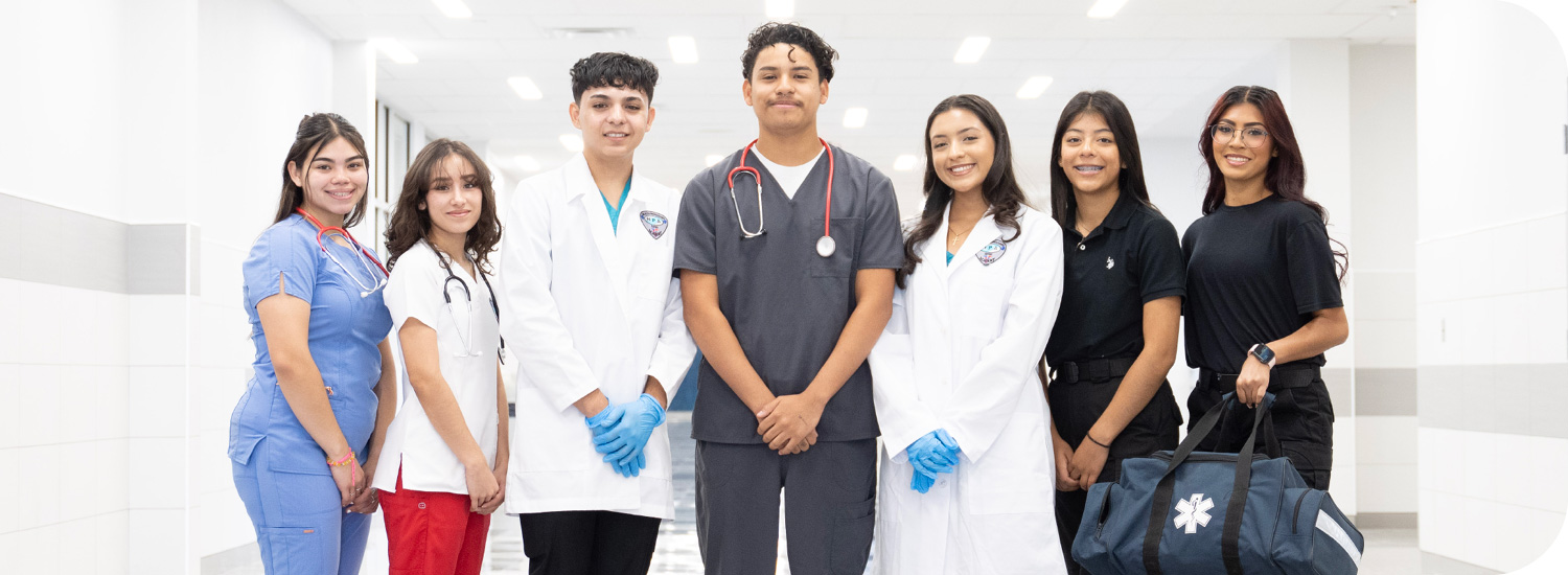 Health Profession students smiling in their program uniforms