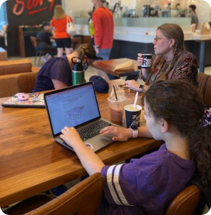 student using laptop in cafe