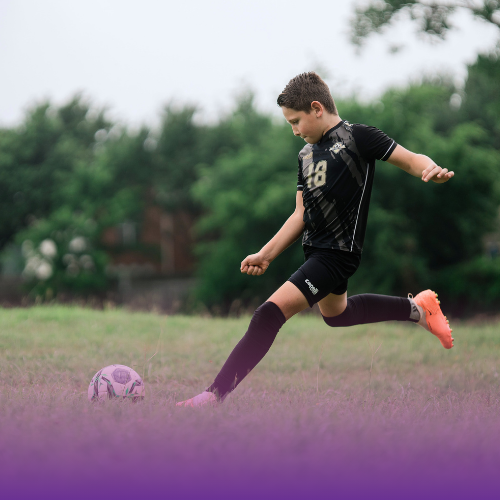 Boy kicking a soccer ball