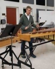 a man plays a xylophone