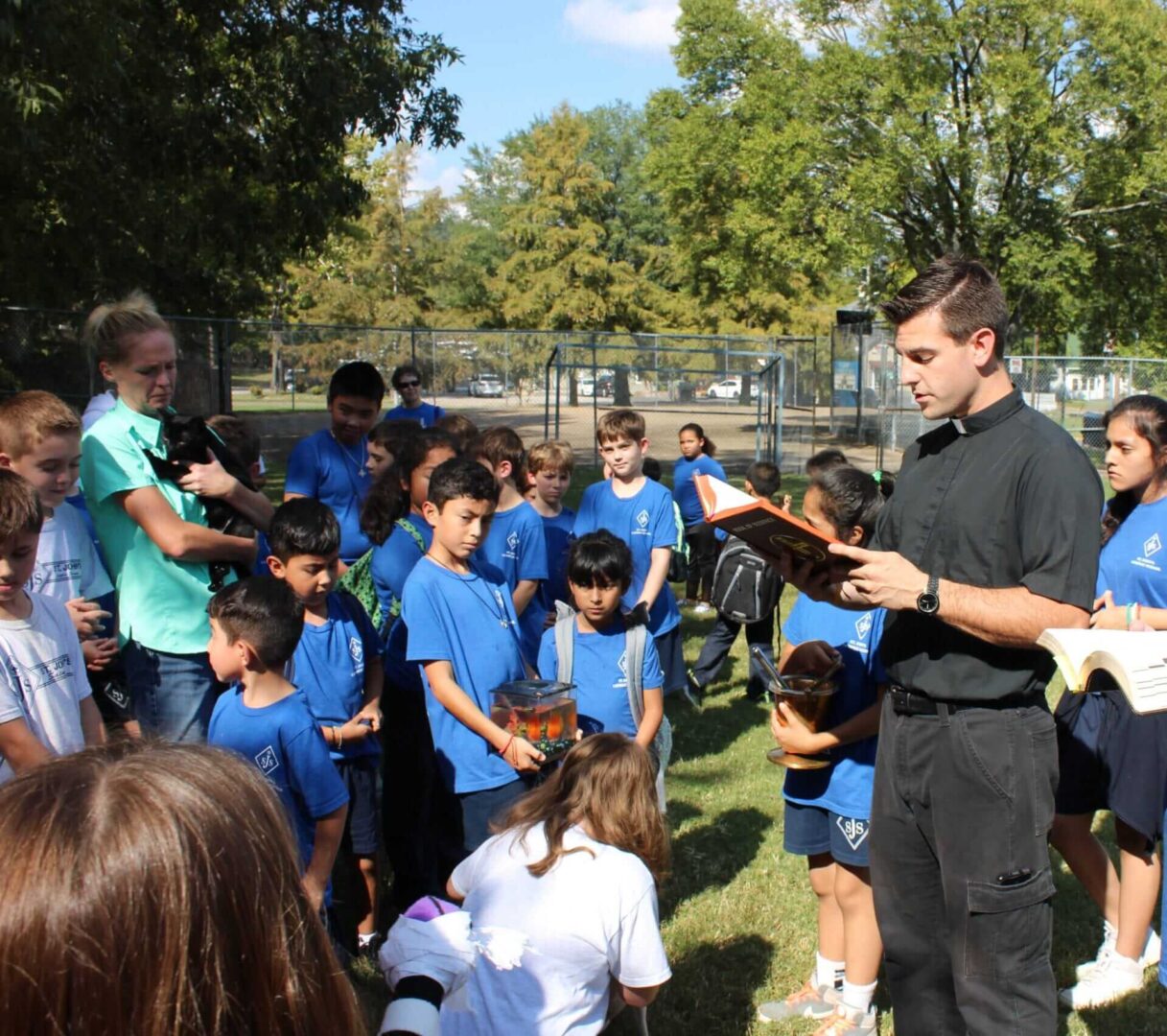 Preacher praying with students