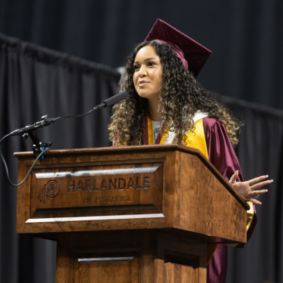 photo of graduate speaking on a podium
