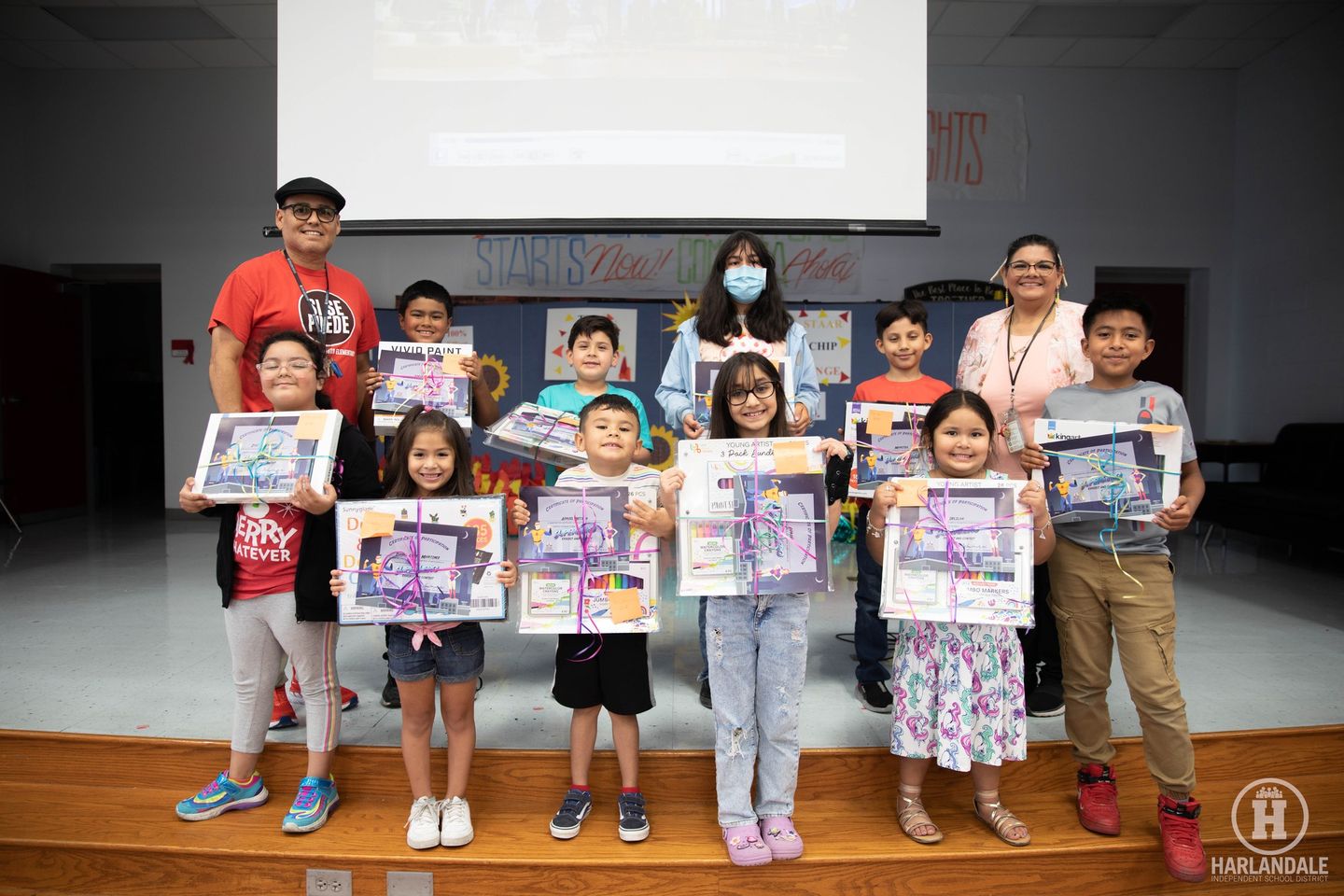 Art students holding their prizes