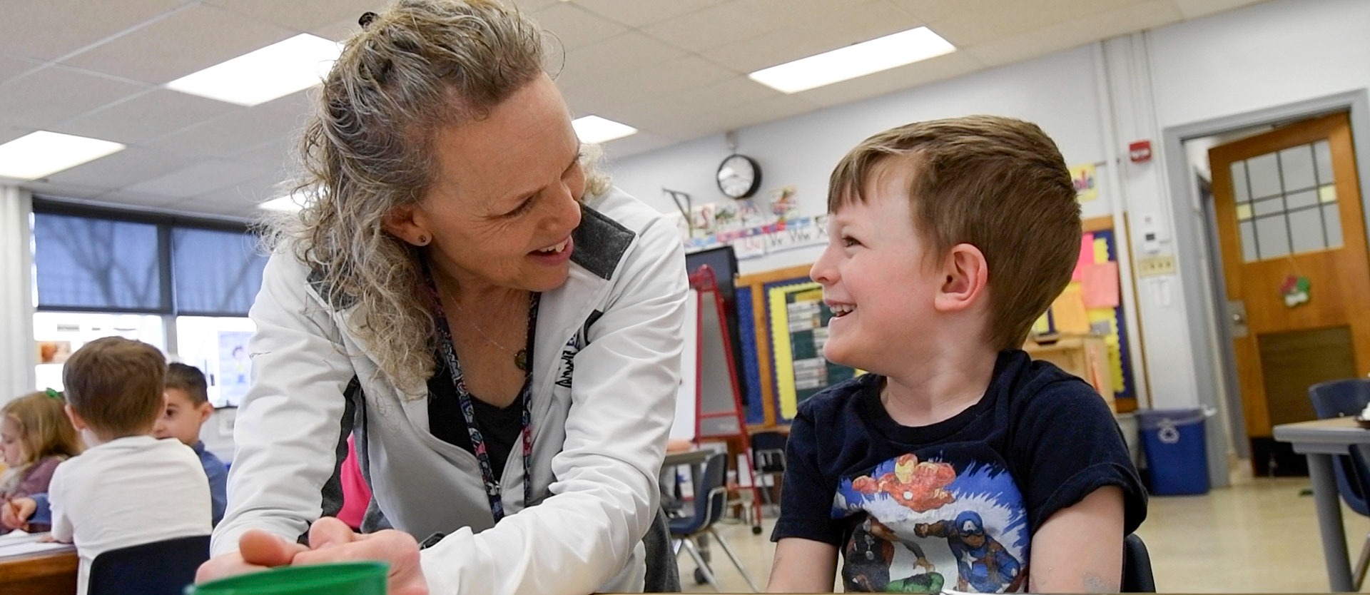 student smiling at teacher