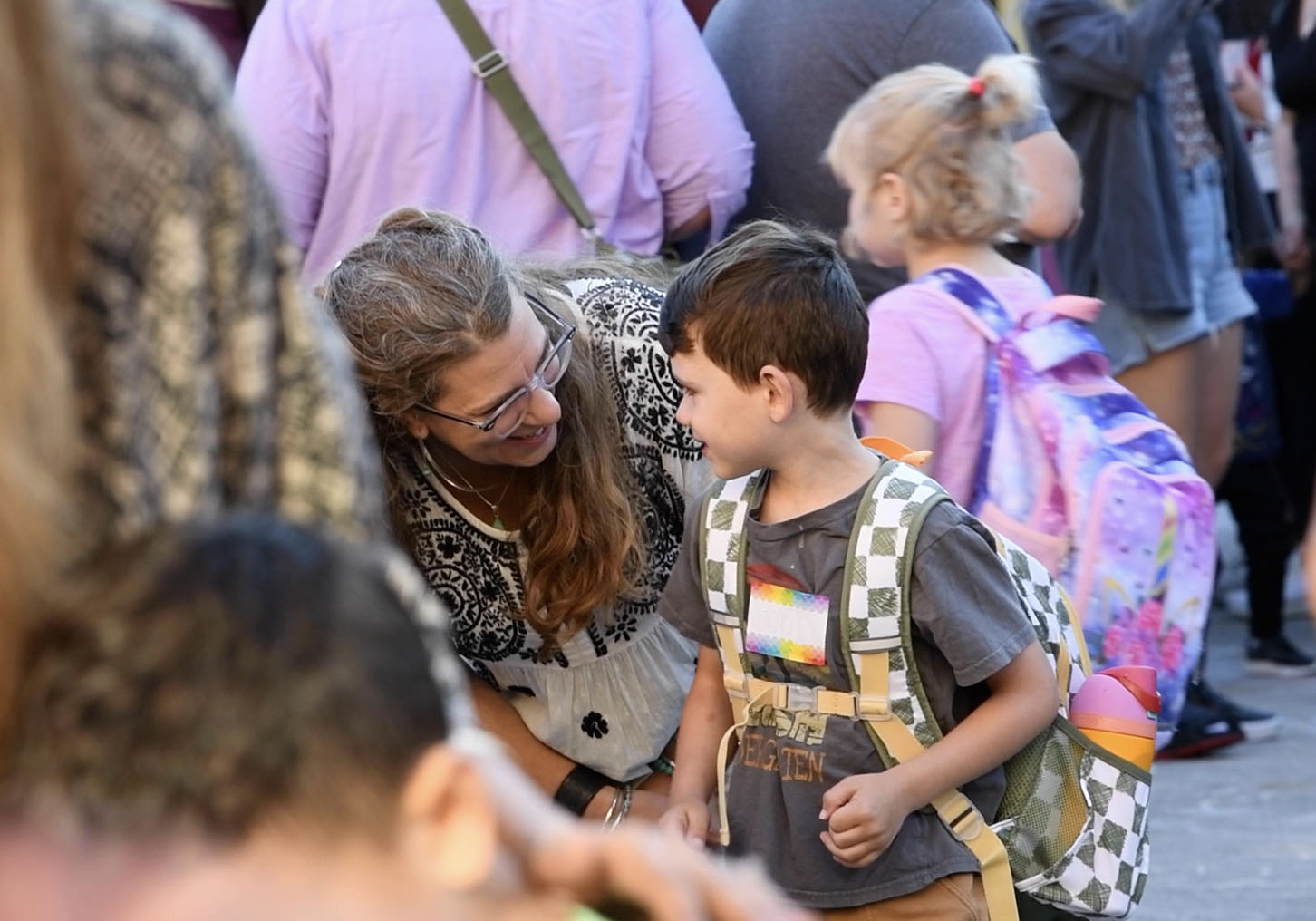 kid smiling at teacher