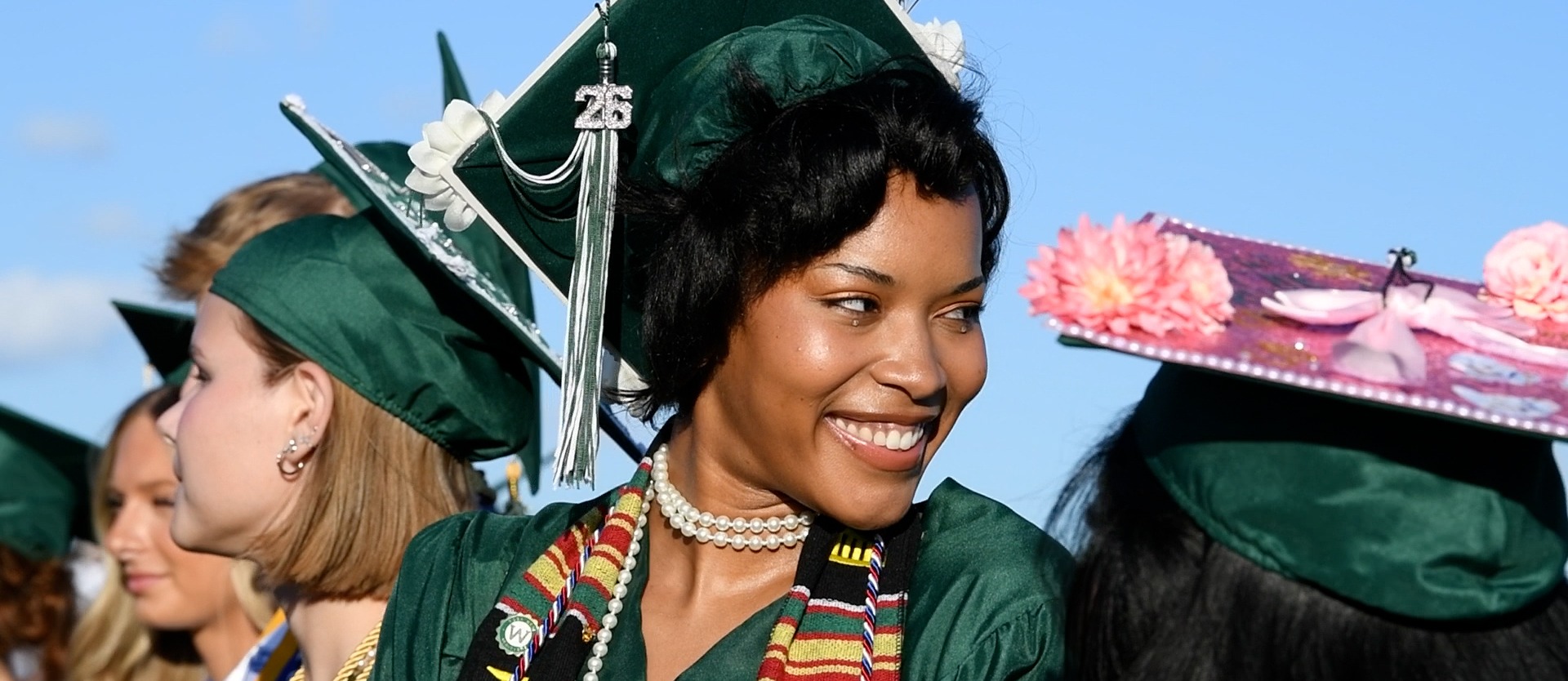 graduate smiling in cap and gown