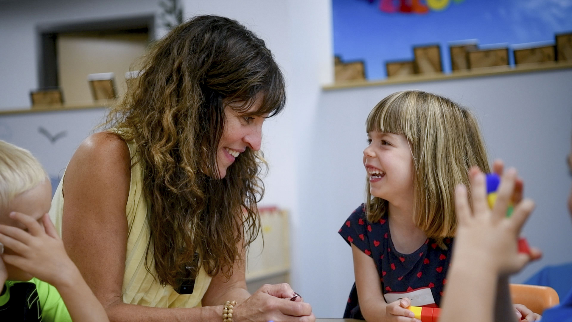 teacher smiling at student smiling