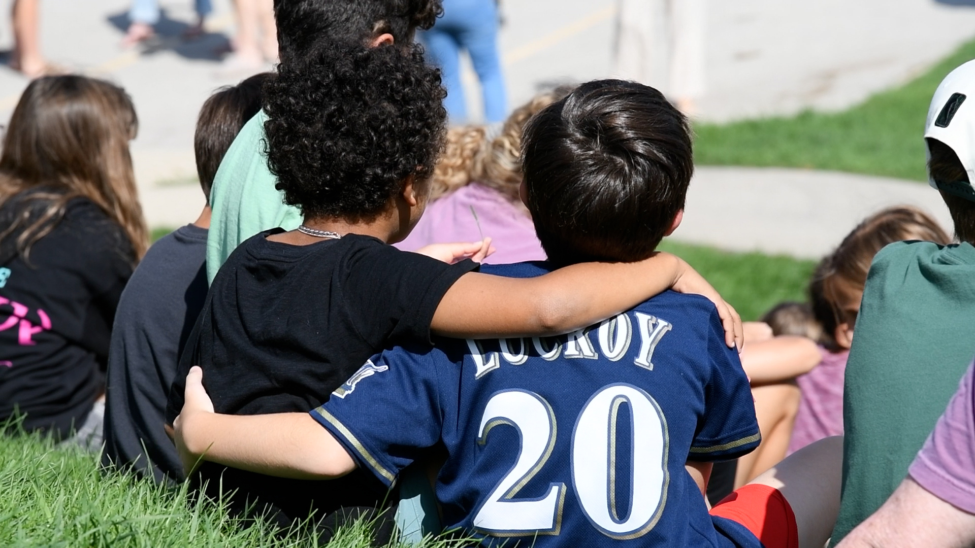 two students with their arm around the other