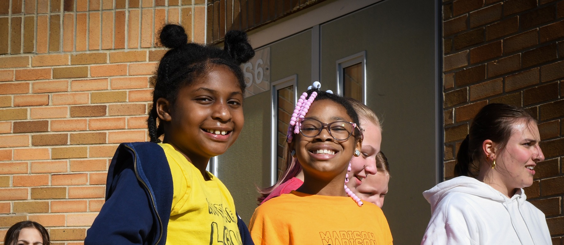 students smiling outside