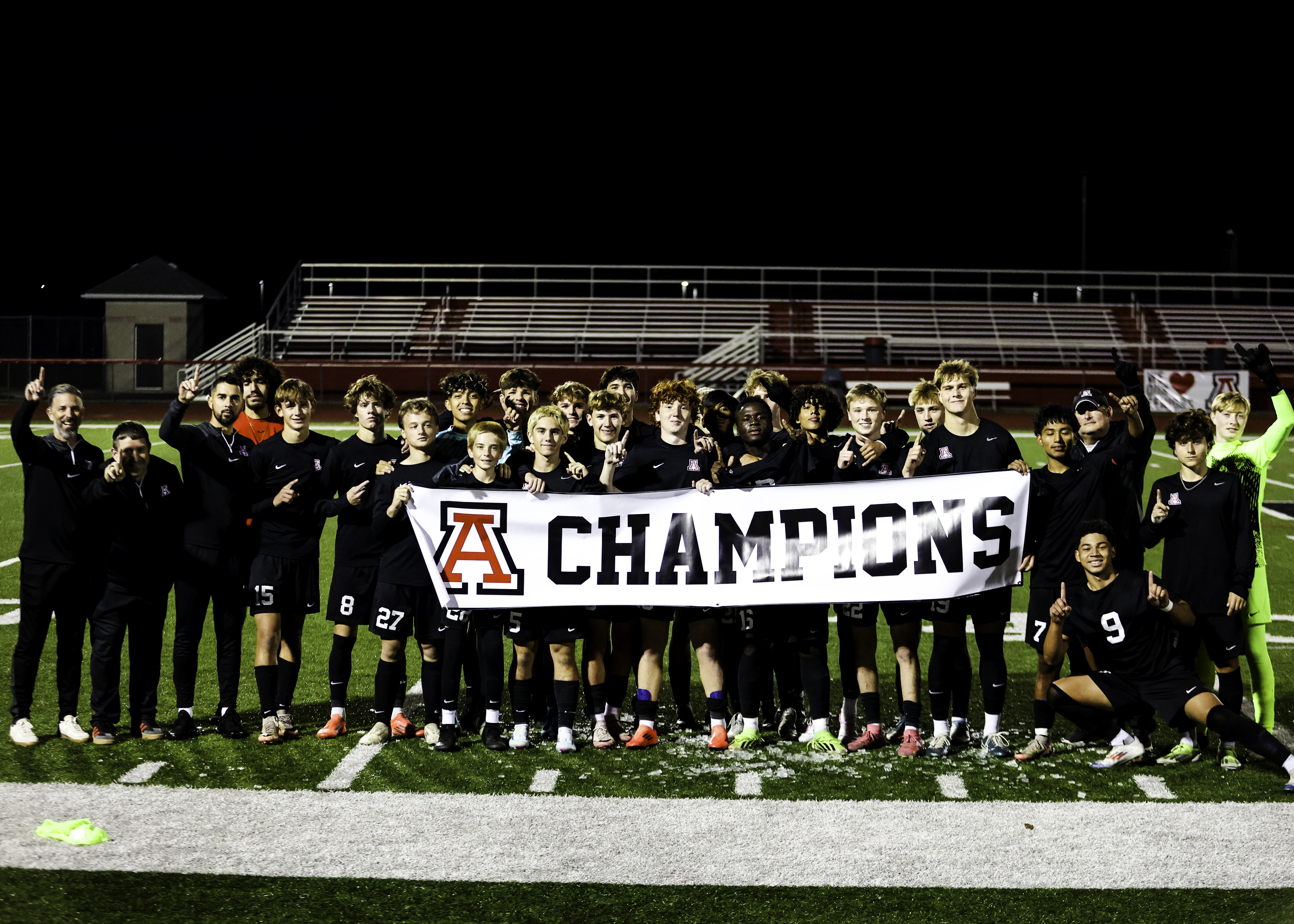 Boys Soccer with champions banner