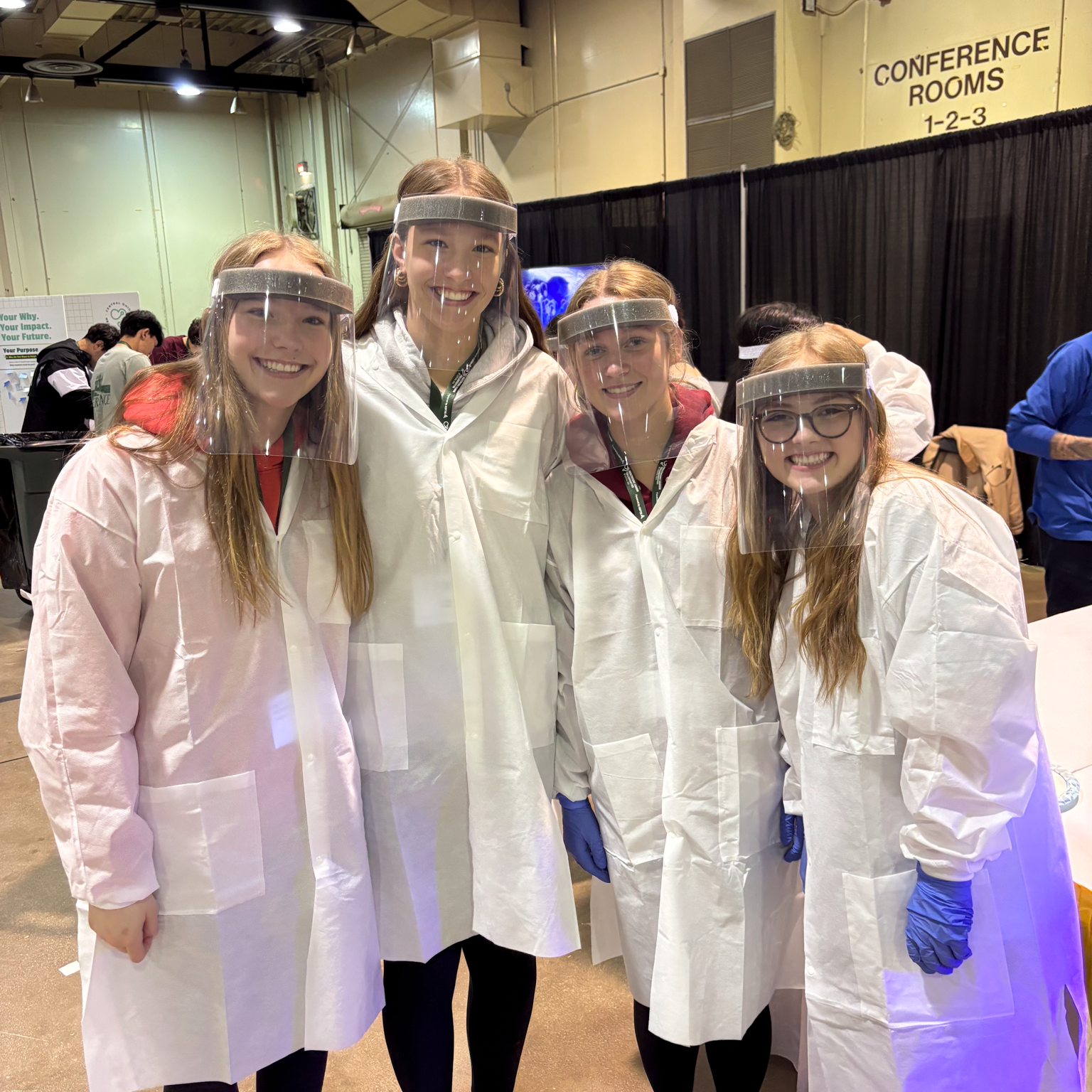 four girls in lab coats