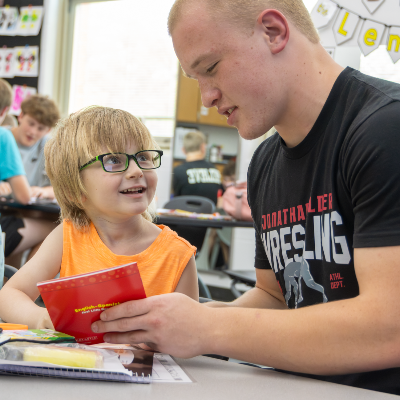 young boy listening to older boy read