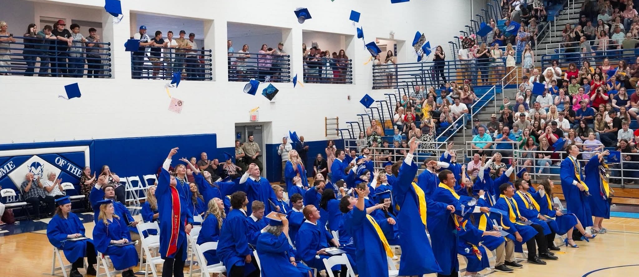CHS Students throwing caps at graduation