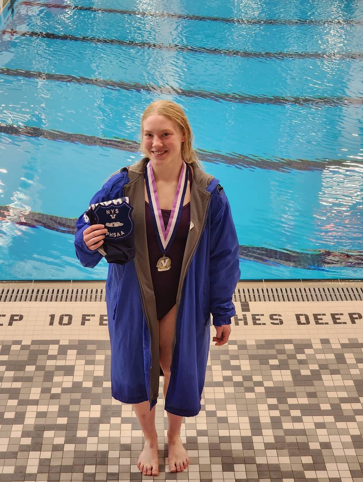 student with swimming award