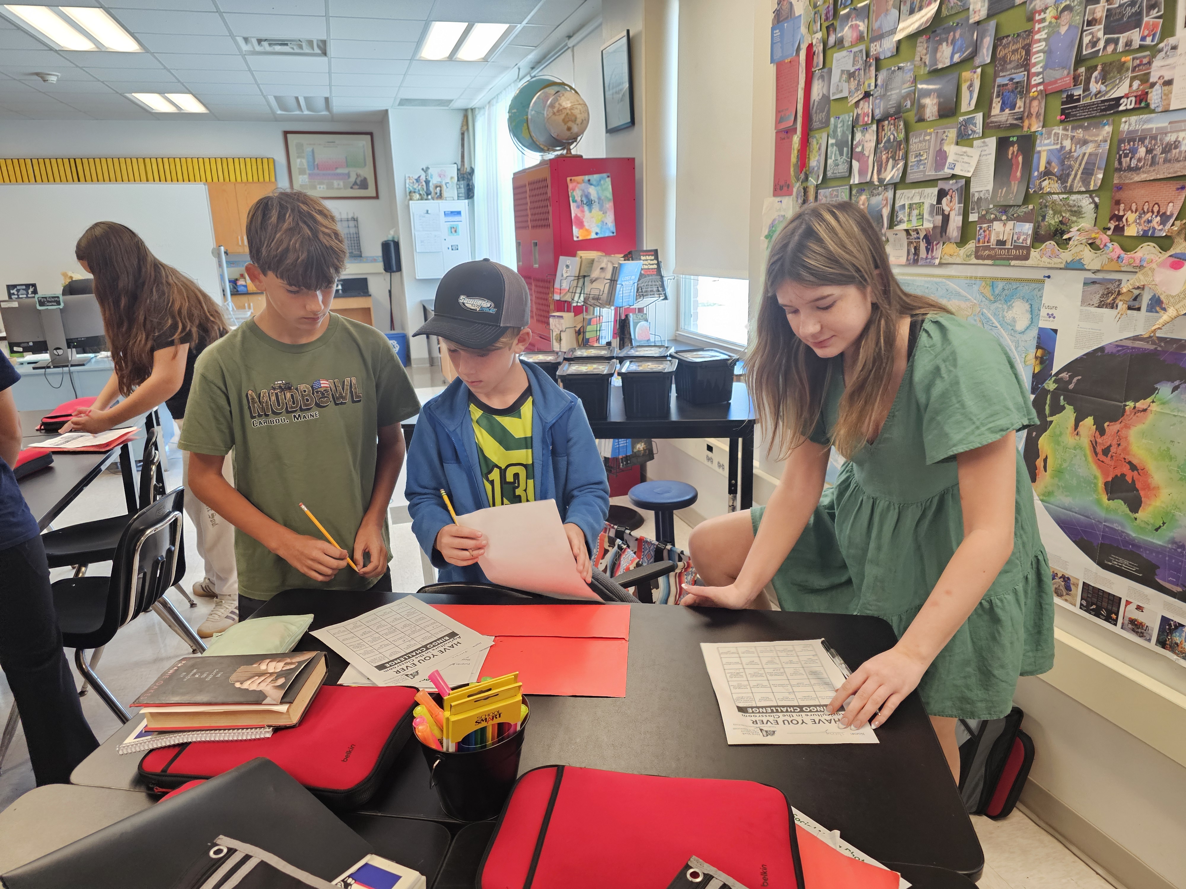 Students working together gathered around a table