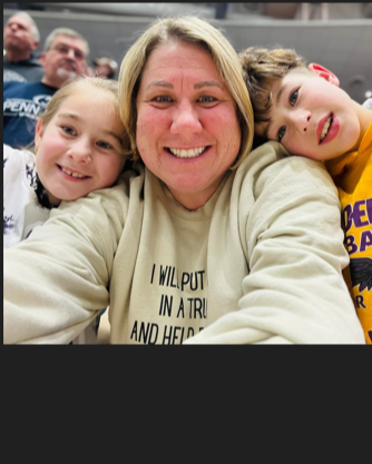 Picture of a mom with her two kids leaning their heads on her shoulders.