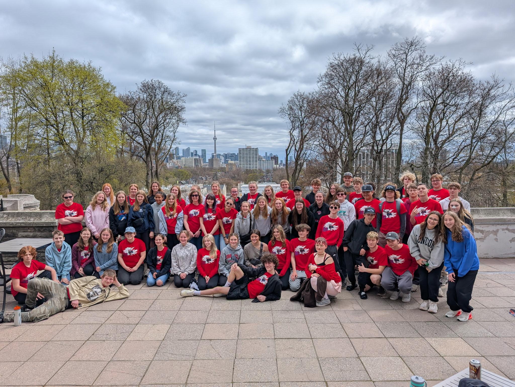 Group photo of band on trip.  Wearing Red Shirts