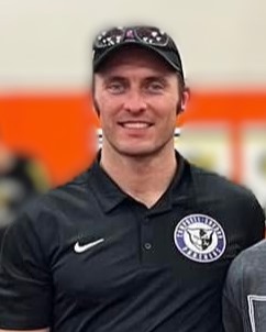 Picture of J Simmons in black colored shirt with panther emblem and hat