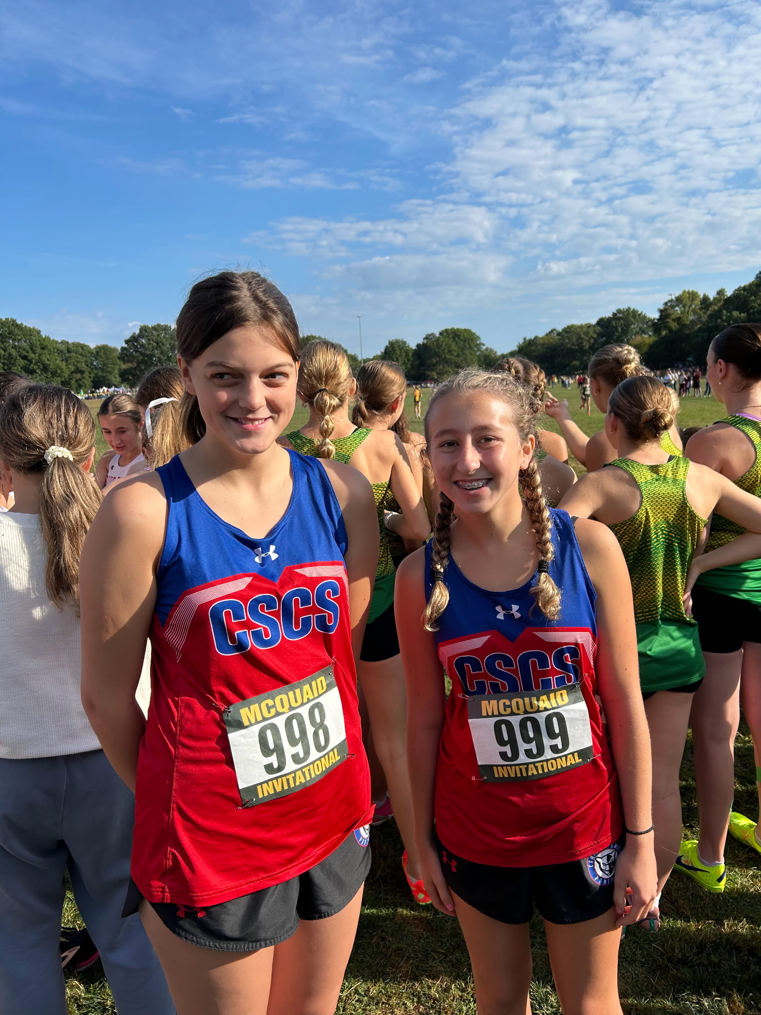 Two cross country runners in uniforms